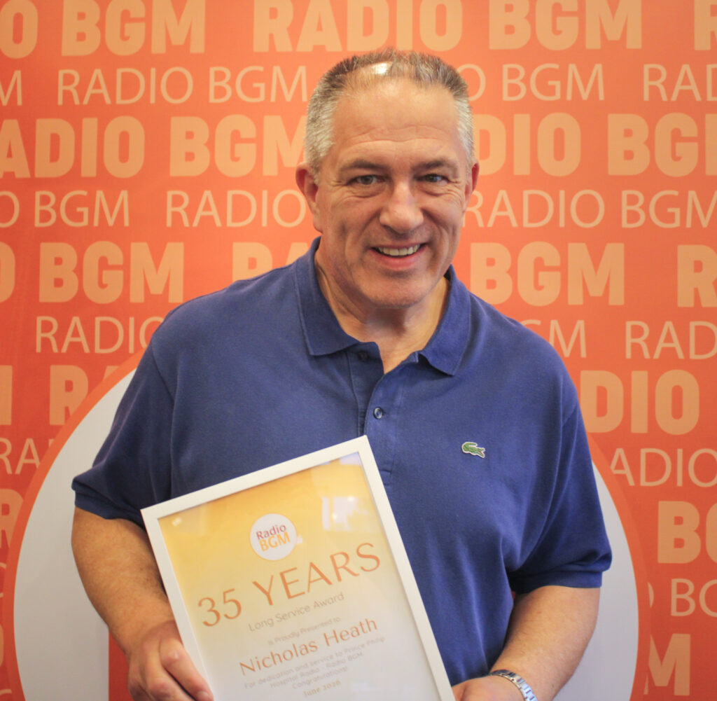 Nicholas Heath proudly holds his 35 Years Long Service Award during Radio BGM's Annual General Meeting.